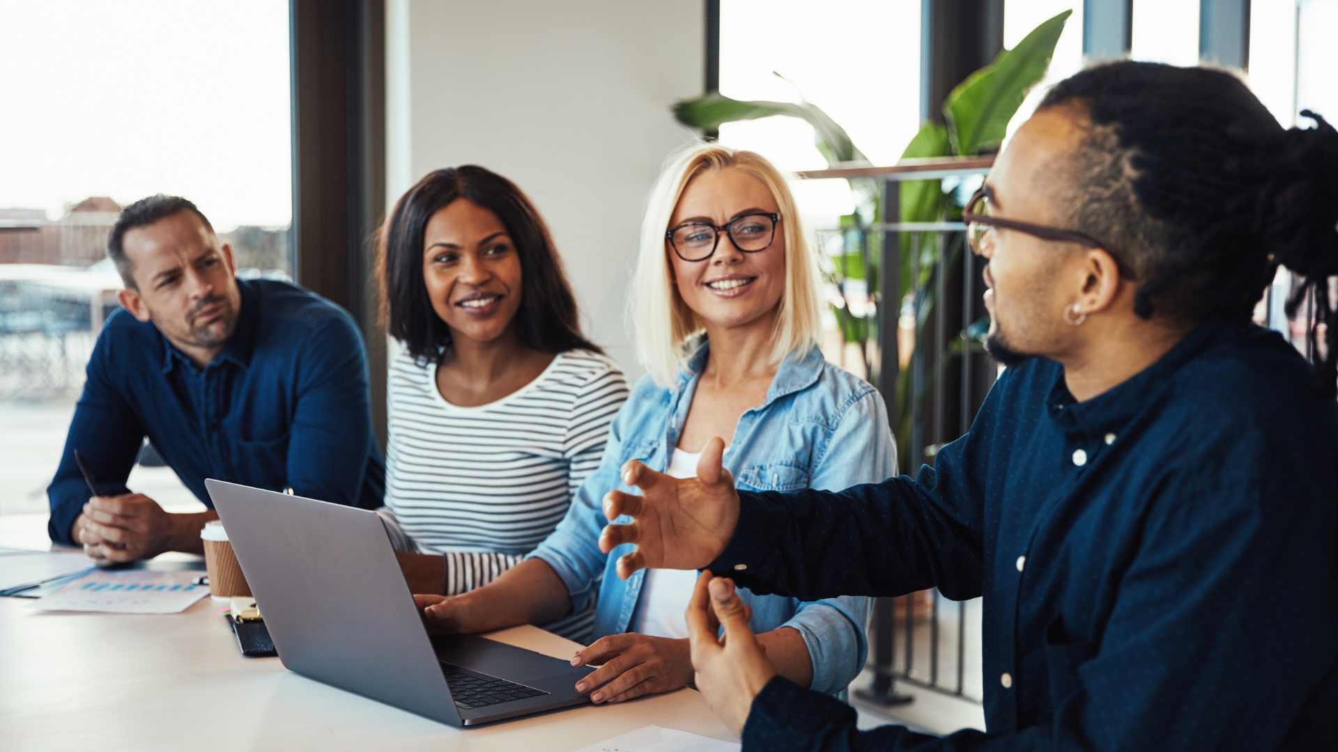 Mentor guiding a startup with charts and keyboard